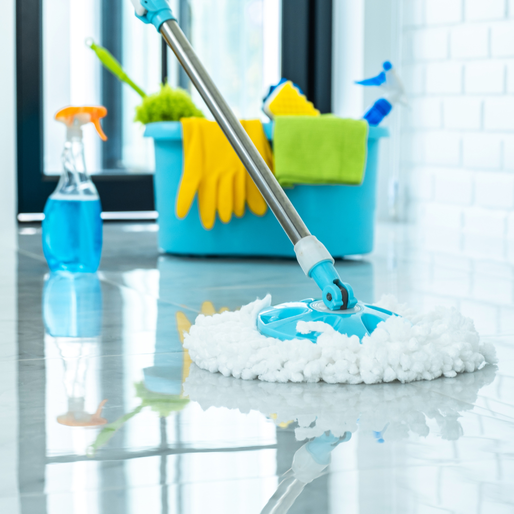 A variety of cleaning products including a mop bucket, mop and supplies